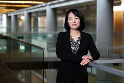 Rose Hu stands in academic building.